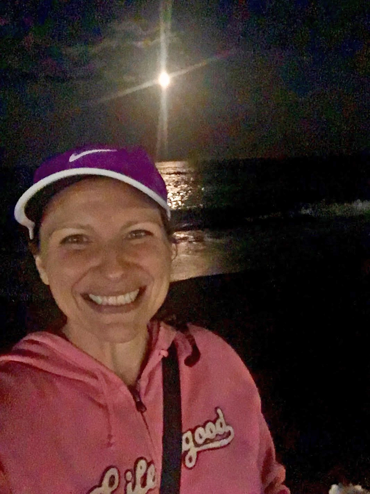 A fake smile as I limped along the beach with Mr. SOTSS and his daughter and a full moon.